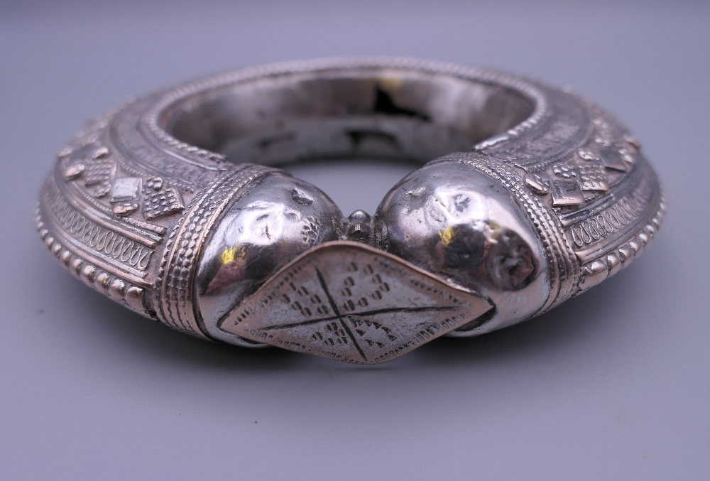 Three Eastern white metal bangles, two probably unmarked silver. The largest 12.5 cm diameter. - Image 9 of 14