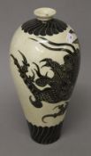 A Chinese pottery vase decorated with a dragon. 31 cm high.