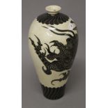 A Chinese pottery vase decorated with a dragon. 31 cm high.