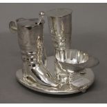 A silver plated jockey cruet set. 9 cm high.