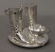 A silver plated jockey cruet set. 9 cm high.