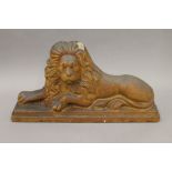 A 19th century stoneware lion. 42.5 cm wide.