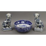 A Wedgwood bowl together with a pair of blue and white dogs