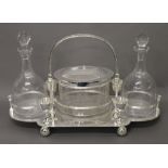 A silver plated biscuit jar and decanter set. 47 cm wide.