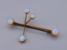 A 9 ct gold moonstone set constellation brooch formed as the Southern Star (Crux). 4.5 cm wide. 2.