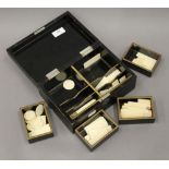 A quantity of Chinese 19th century bone gaming counters, in lacquered box. The box 22.5 cm wide.