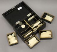 A quantity of Chinese 19th century bone gaming counters, in lacquered box. The box 22.5 cm wide.