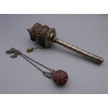 An unmarked silver Tibetan prayer wheel. 20 cm long.