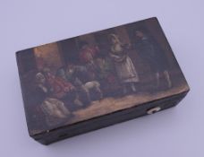 A small 19th century Continental toleware music box, the lid painted with a tavern exterior scene.