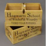 A pair of 'Hogwarts' wooden boxes. 30 cm wide.