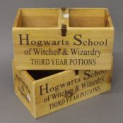 A pair of 'Hogwarts' wooden boxes. 30 cm wide.