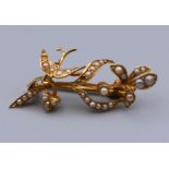A boxed 15 ct gold seed pearl set bird on leaf brooch. 3.5 cm wide. 2.6 grammes total weight.