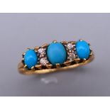 An 18 ct gold diamond and turquoise ring. Ring size M. 2.7 grammes total weight.