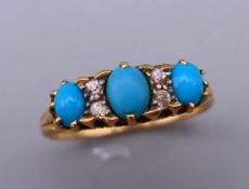 An 18 ct gold diamond and turquoise ring. Ring size M. 2.7 grammes total weight.