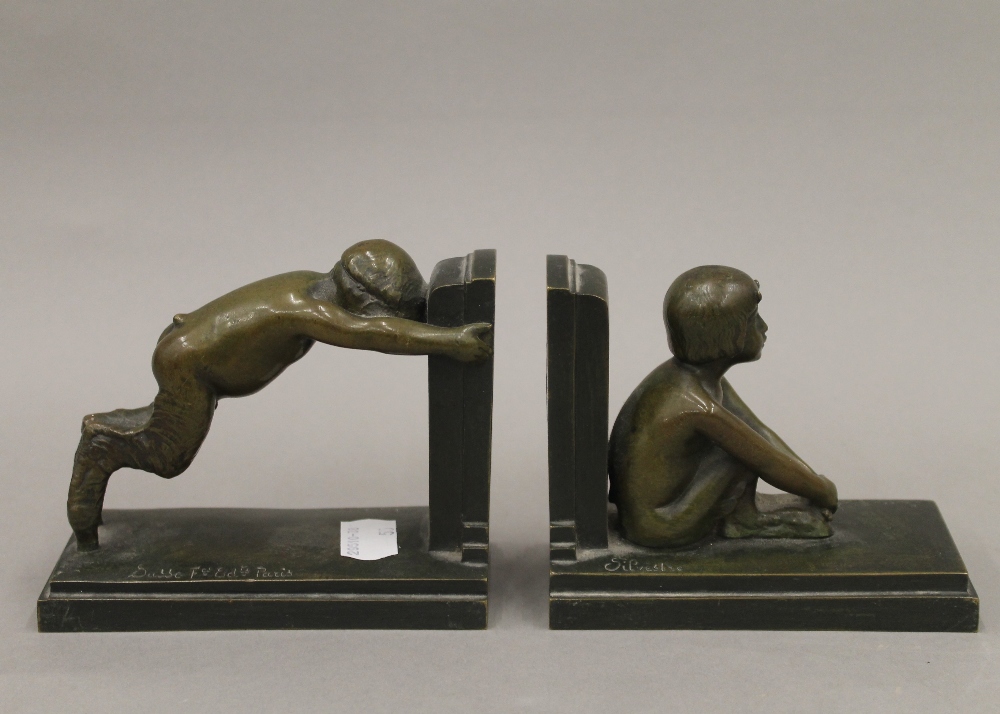 A pair of Art Deco patinated bronze bookends formed as fauns by Paul Silvestre,