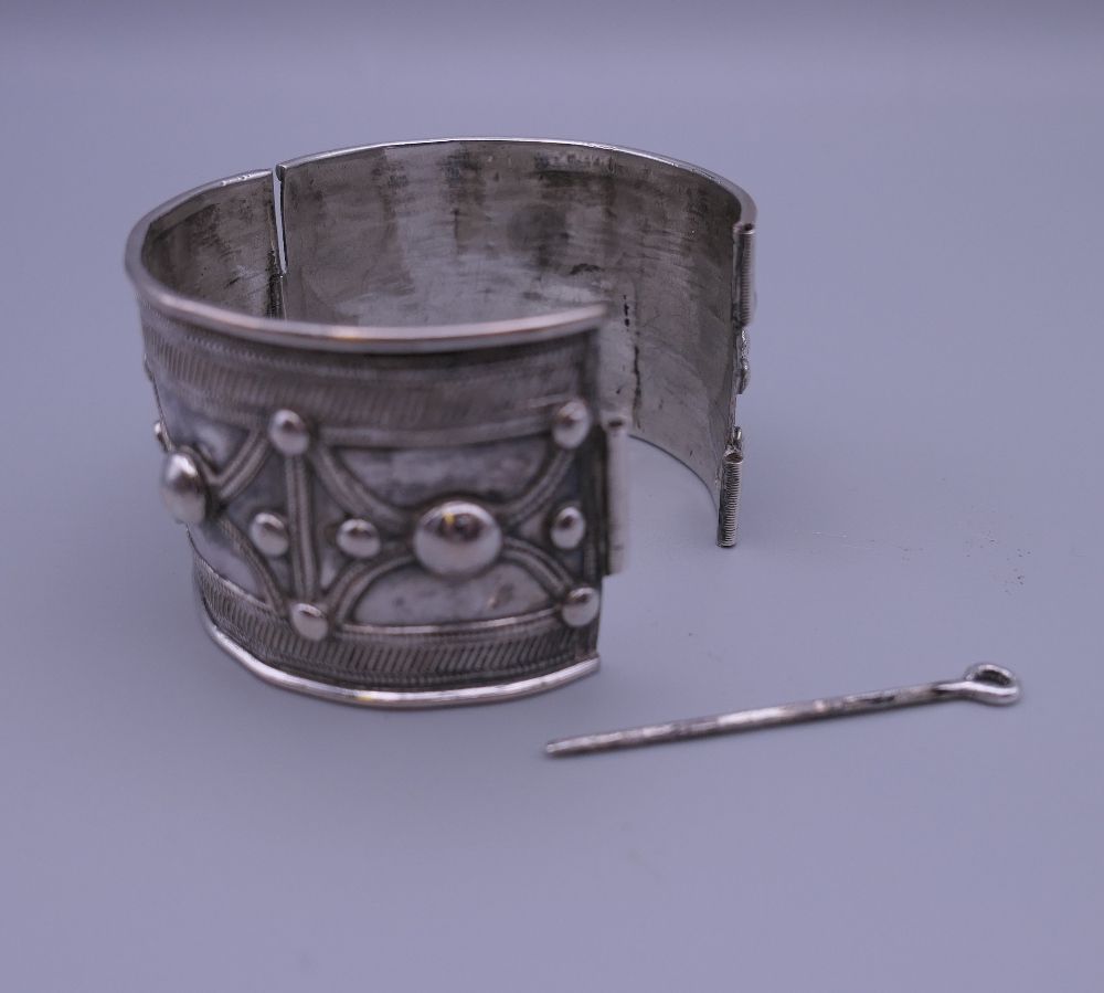 Three Eastern white metal bangles, two probably unmarked silver. The largest 12.5 cm diameter. - Image 5 of 14