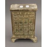 A Tang Dynasty pottery part green glazed model of a standing chest, with traces of iridescence. 21.
