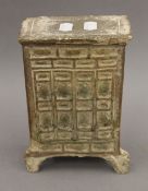 A Tang Dynasty pottery part green glazed model of a standing chest, with traces of iridescence. 21.