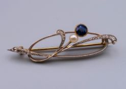 A boxed 14 ct gold diamond, sapphire and pearl brooch. 4.5 cm wide. 5 grammes total weight.