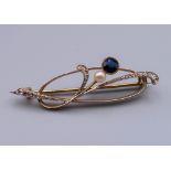 A boxed 14 ct gold diamond, sapphire and pearl brooch. 4.5 cm wide. 5 grammes total weight.