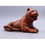 A carved wooden model of a tiger. 14.5 cm long.