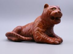A carved wooden model of a tiger. 14.5 cm long.