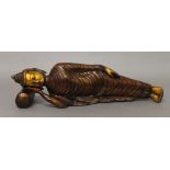 A bronze figure of a reclining Buddha. 33 cm long.