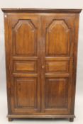 A modern 18th century style oak two door wardrobe. 104 cm wide.