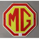 A cast iron 'MG' sign. 24 cm wide.