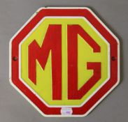 A cast iron 'MG' sign. 24 cm wide.