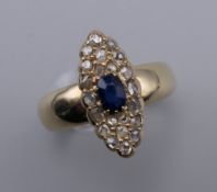 An antique 18 ct gold (tested) pave set diamond and sapphire navette shaped ring. Ring size P. 6.