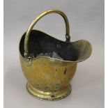 A Victorian brass coal scuttle.