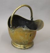 A Victorian brass coal scuttle.