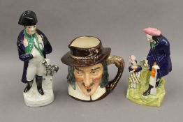 Two Royal Doulton character jugs together with two Staffordshire figures. The largest 28 cm high.