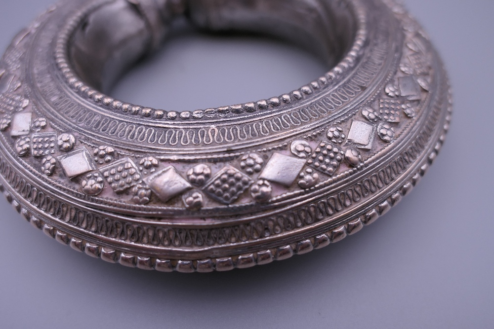 Three Eastern white metal bangles, two probably unmarked silver. The largest 12.5 cm diameter. - Image 14 of 14