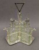 A silver plated three bottle decanter stand. 34 cm high.