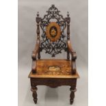 A 19th century inlaid Black Forest musical open armchair. 65 cm wide.