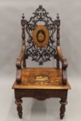 A 19th century inlaid Black Forest musical open armchair. 65 cm wide.