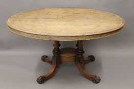 A Victorian inlaid walnut loo table. 136 cm long.