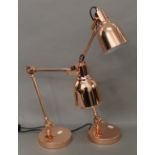 A pair of copper adjustable lamps. 55 cm high.