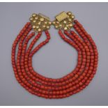 A string of coral with an unmarked 18 ct gold clasp. 41 cm long.