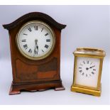 An Edwardian mahogany mantle clock and a carriage clock. The former 20 cm high.