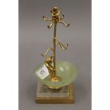 A gilt metal jewellery stand formed as a bear and a cherub, set with a jade bowl. 17 cm high.