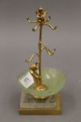 A gilt metal jewellery stand formed as a bear and a cherub, set with a jade bowl. 17 cm high.