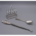 An Asprey silver toast rack , a silver handled button hook and a silver teaspoon.