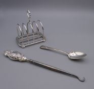 An Asprey silver toast rack , a silver handled button hook and a silver teaspoon.