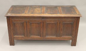 An 18th century oak four panel coffer. 127 cm long.