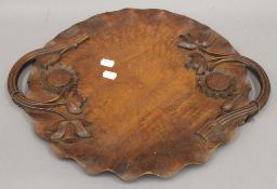 An Eastern carved wooden tray with floral decoration. 46.5 cm wide.