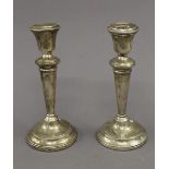 A pair of silver candlesticks. Each 19.5 cm high. 28.1 troy ounces weighted.