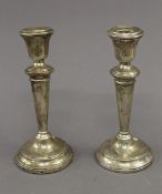 A pair of silver candlesticks. Each 19.5 cm high. 28.1 troy ounces weighted.
